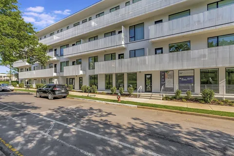 a view of a building with a yard