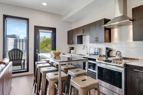 a kitchen with a sink appliances and cabinets