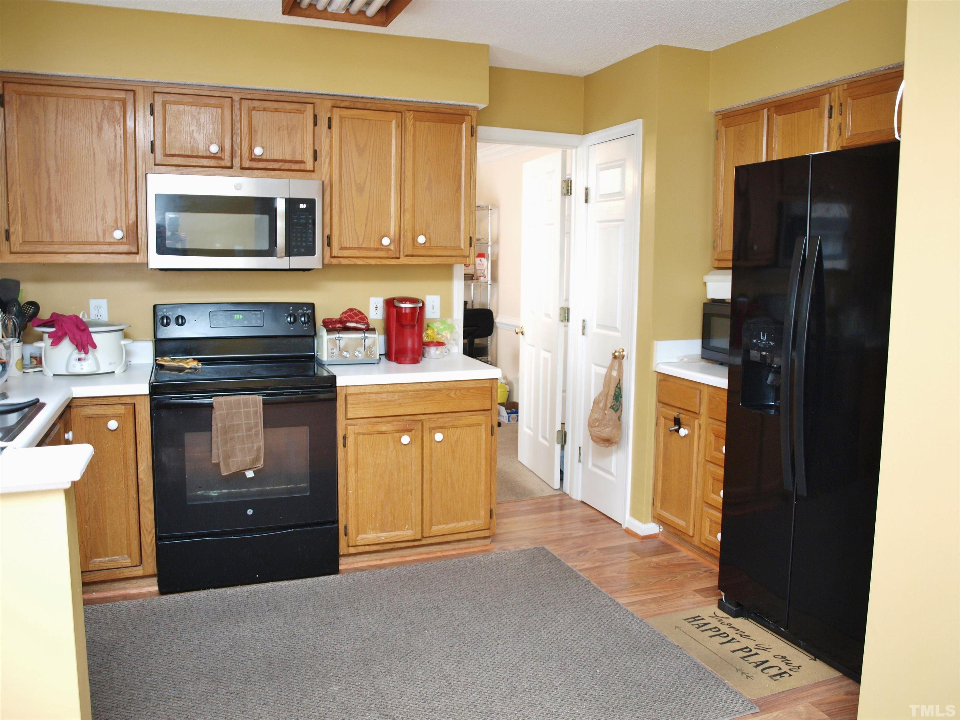 4621 Fox Road Raleigh, NC 27616 - Photo 4 of 14 a kitchen with a refrigerator stove and microwave
