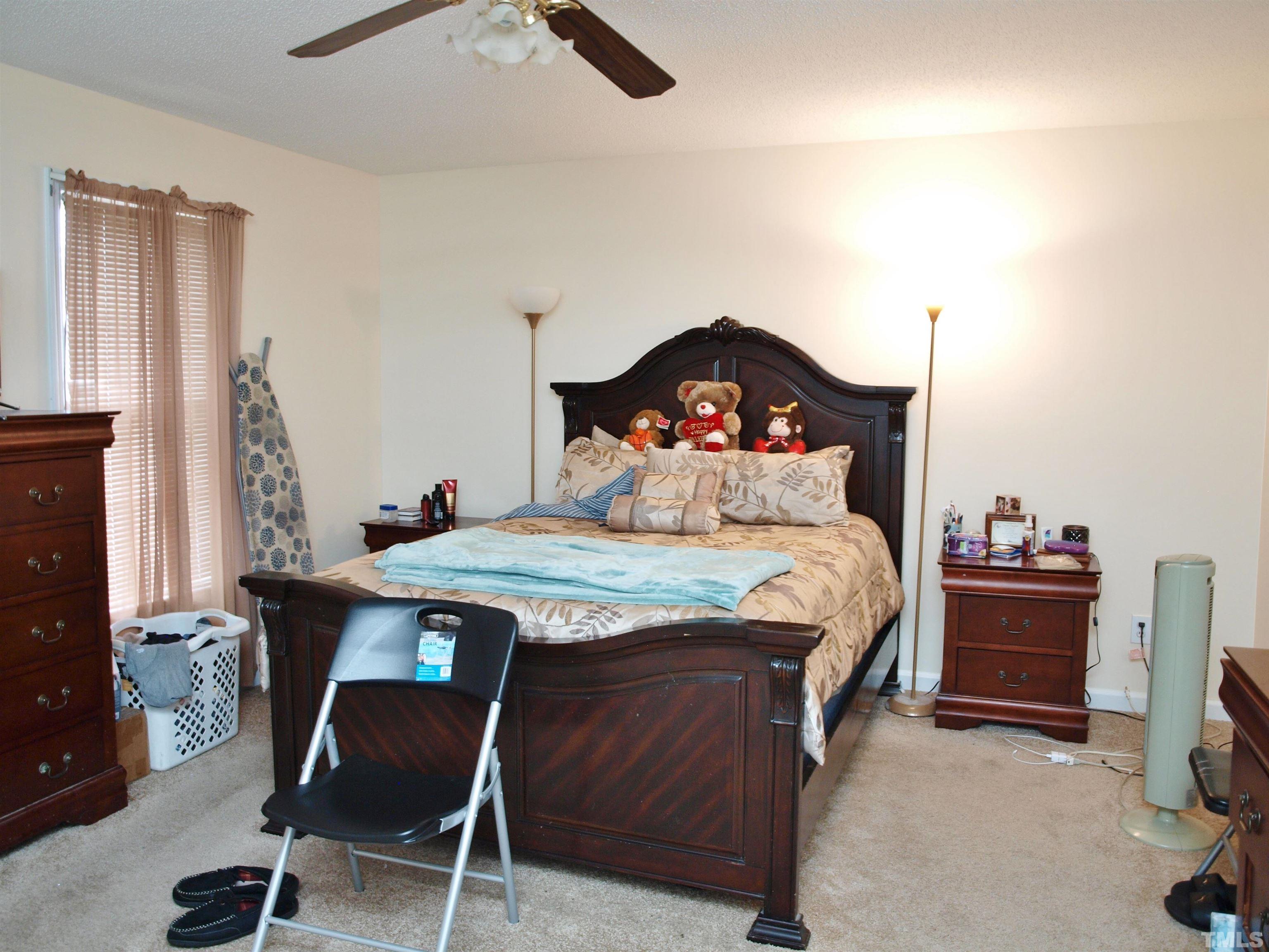 4621 Fox Road Raleigh, NC 27616 - Photo 7 of 14 a bedroom with a bed and a dresser in it