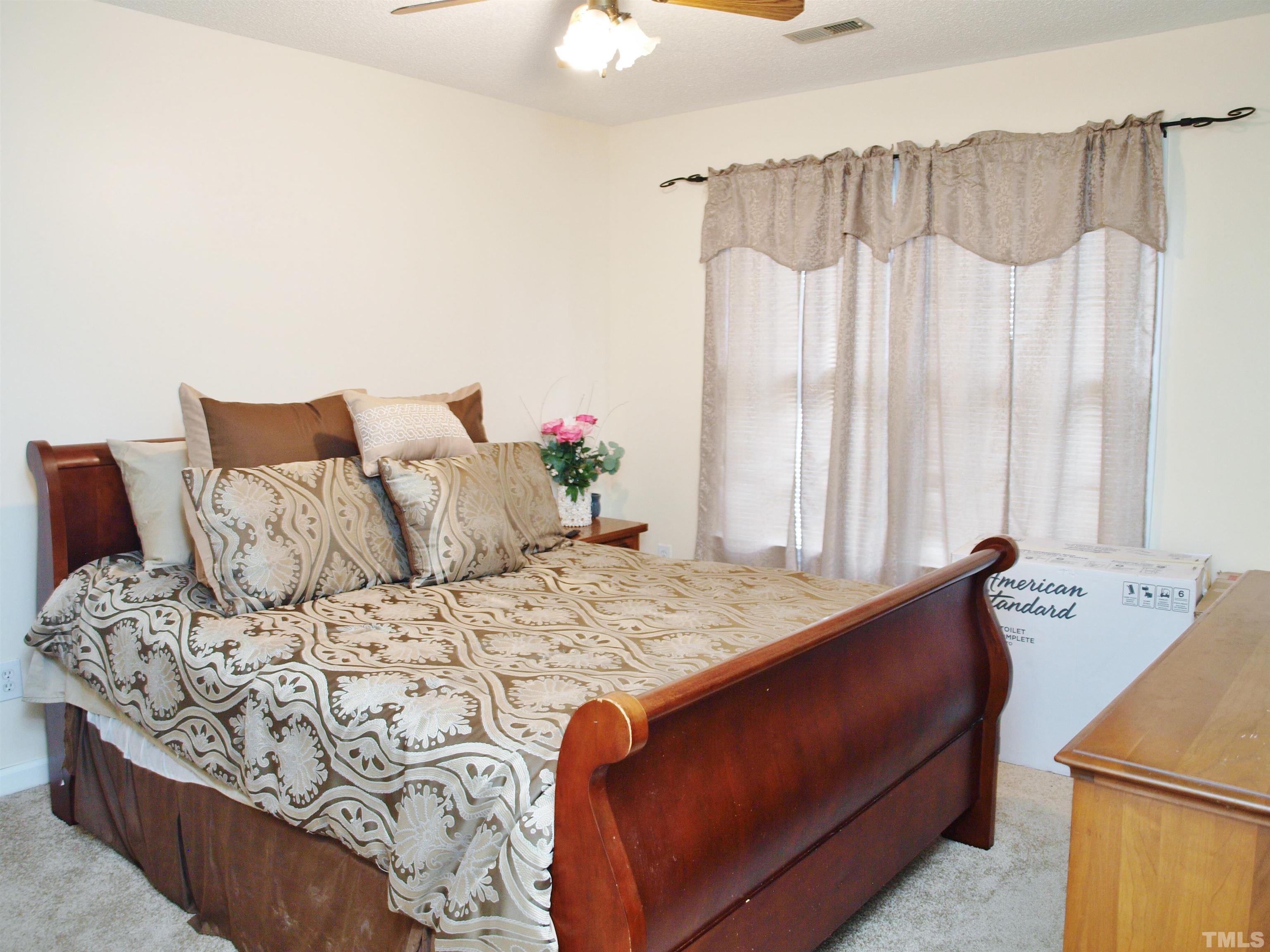 4621 Fox Road Raleigh, NC 27616 - Photo 10 of 14 a bedroom with a bed and a table