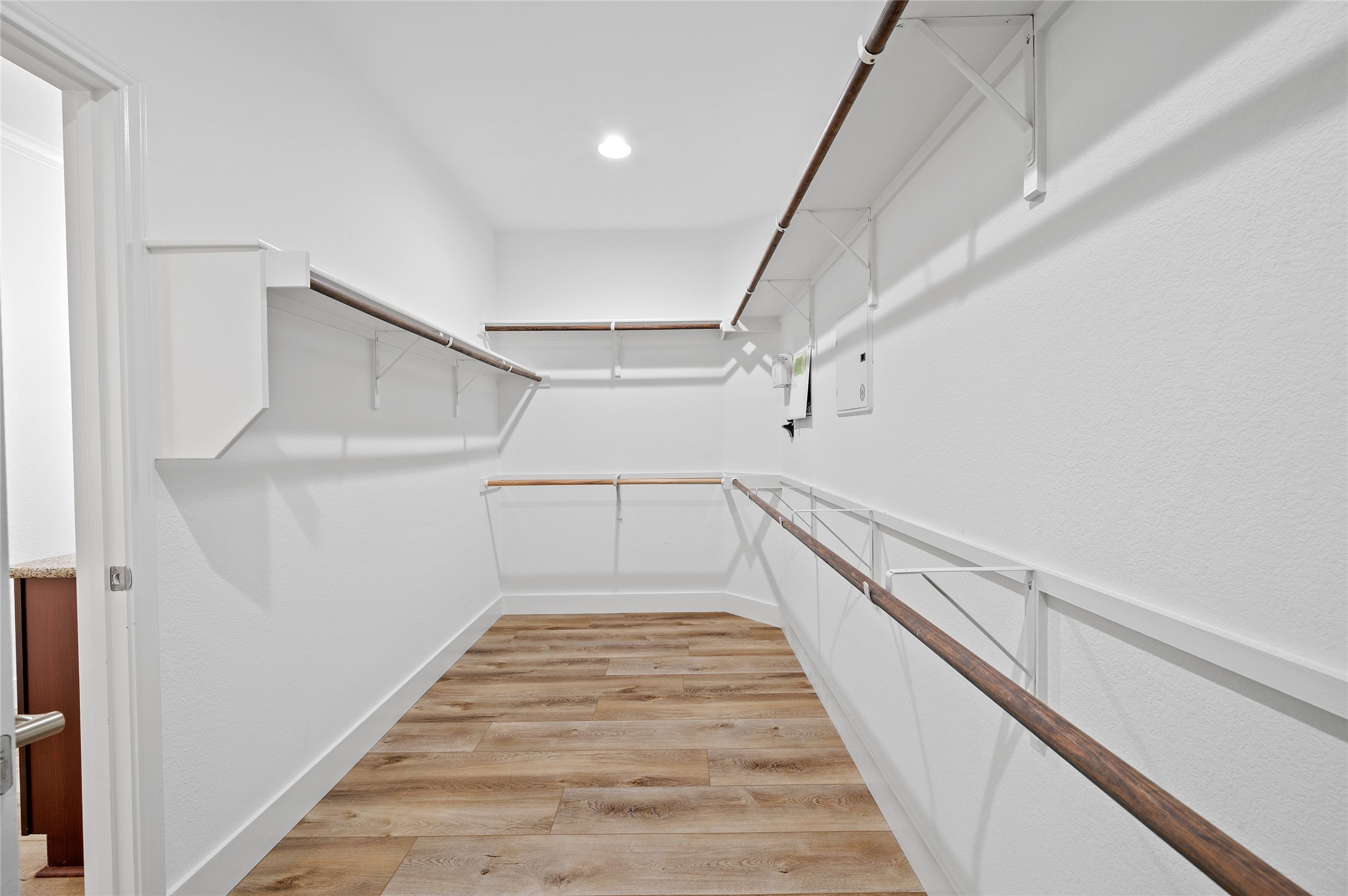 4512 Pyrenees Pass Bee Cave, TX 78738 - Photo 21 of 35 a view of a hallway with wooden floor and staircase