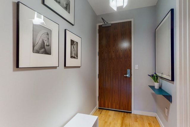 a living room with furniture kitchen view and a window