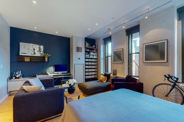a living room with furniture a view of kitchen and dining room