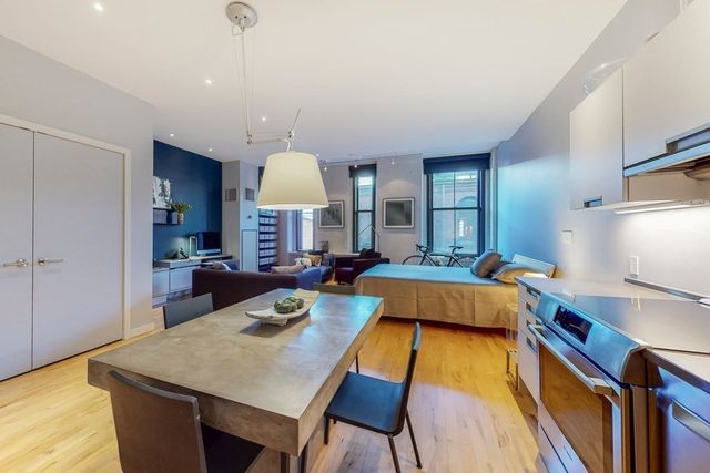 a kitchen with sink refrigerator and microwave
