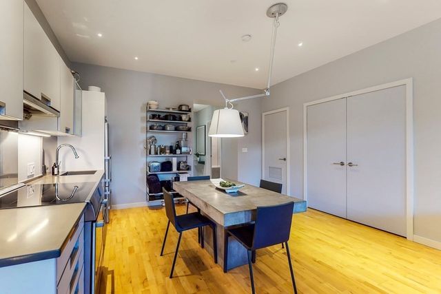 a kitchen with refrigerator and sink