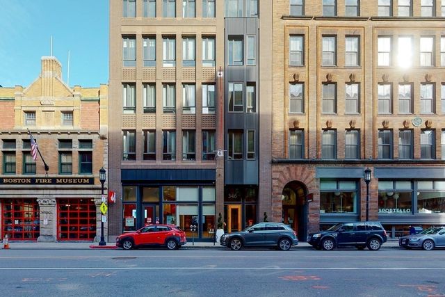 a buildings with car parked in front of it