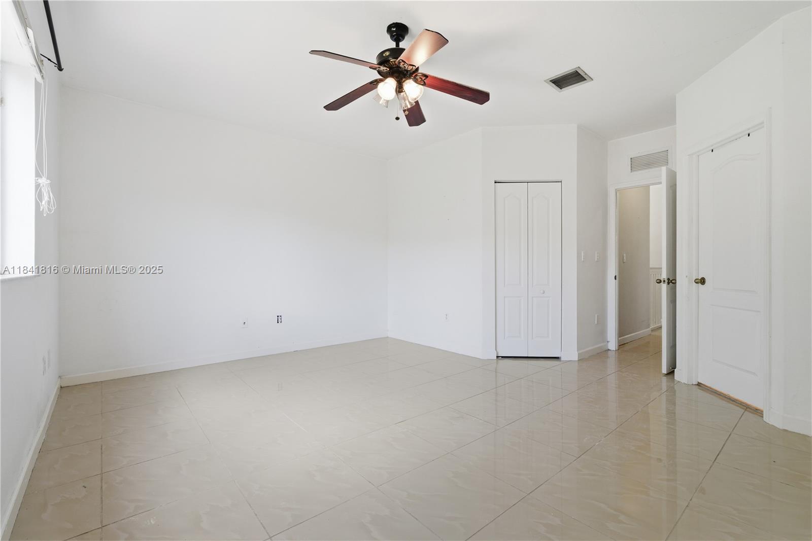 21460 Southwest 85th Passage Cutler Bay, FL 33189 - Photo 16 of 20 wooden floor in an empty room with a chandelier fan