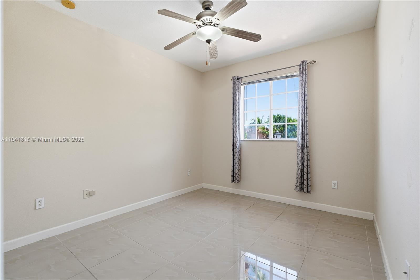 21460 Southwest 85th Passage Cutler Bay, FL 33189 - Photo 9 of 20 an empty room with windows and fan