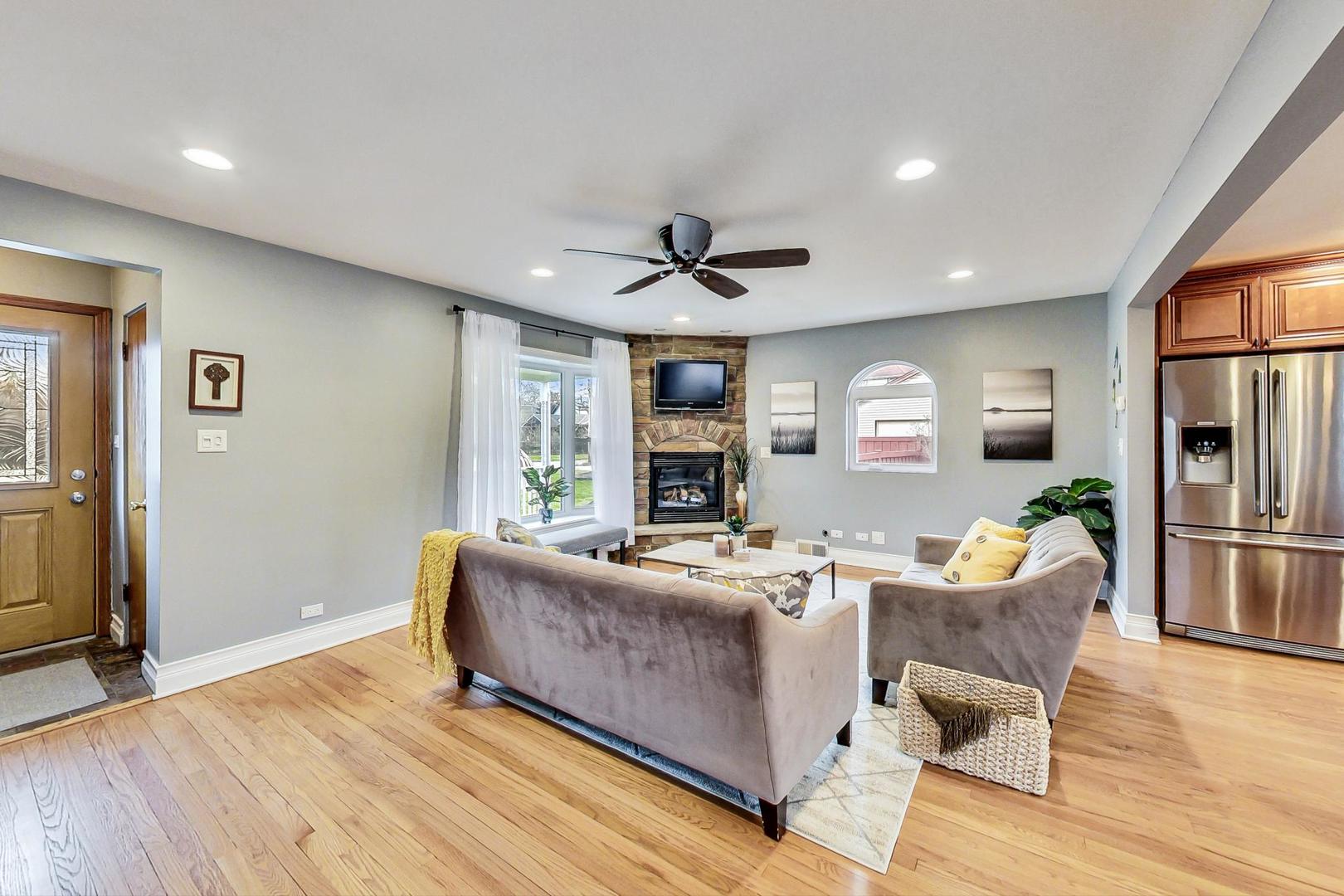 220 Waubansee Road Riverside, IL 60546 - Photo 3 of 24 a living room with fireplace furniture and a wooden floor