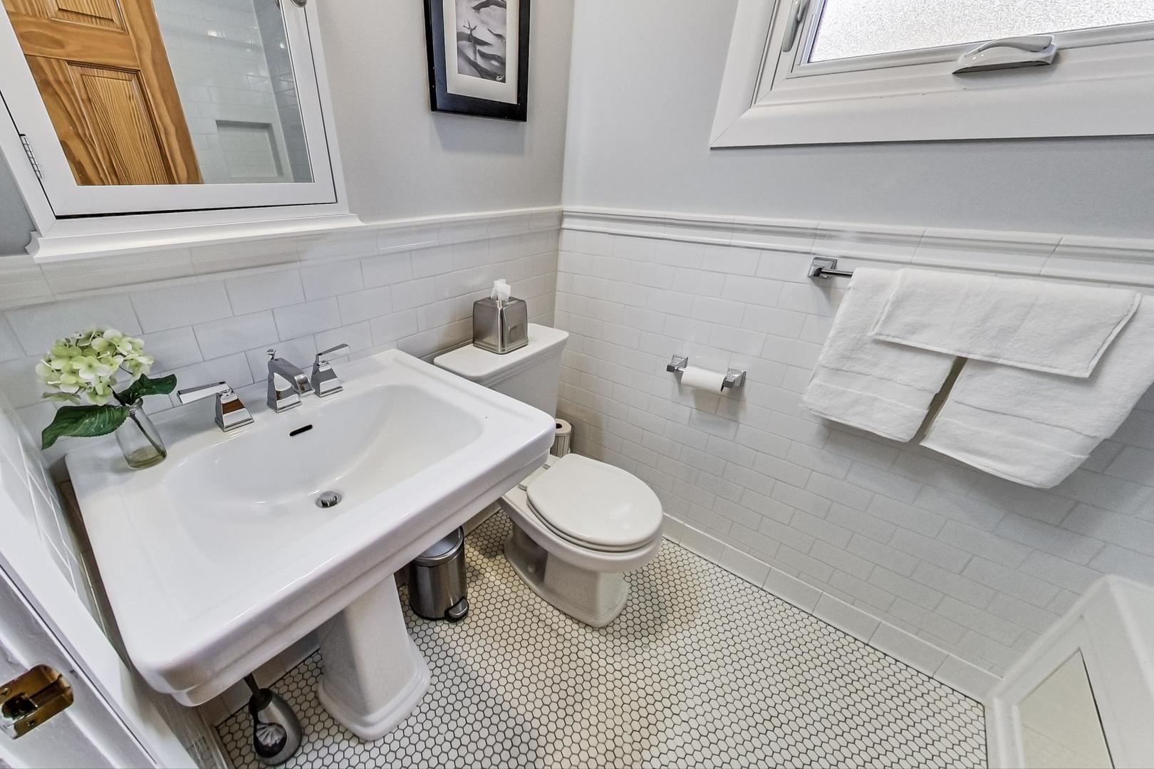 220 Waubansee Road Riverside, IL 60546 - Photo 9 of 24 a white toilet sitting next to a bathroom sink