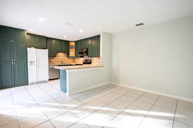a kitchen with stainless steel appliances a sink and a refrigerator