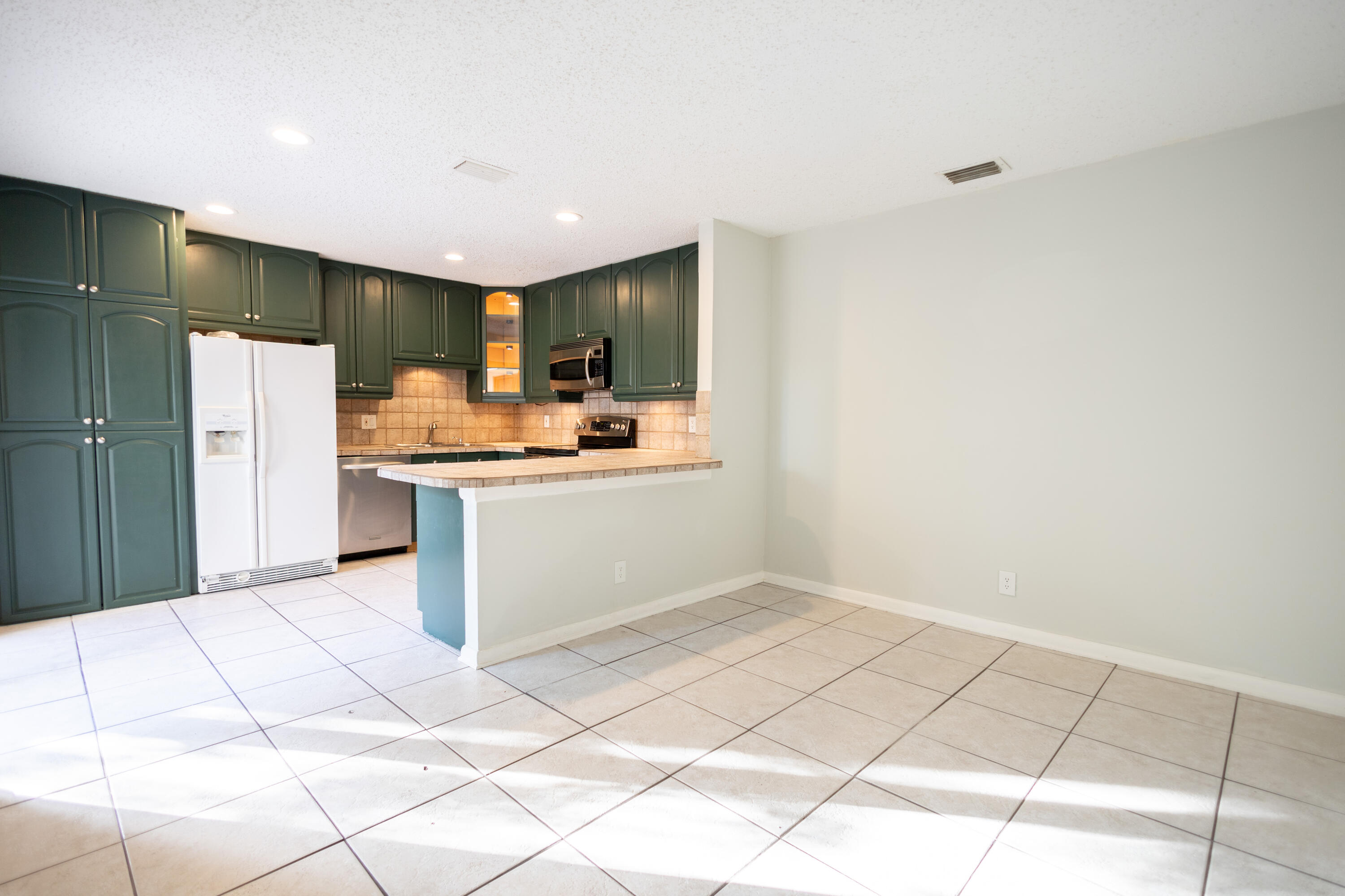 1640 Shaker Circle Wellington, FL 33414 - Photo 7 of 14 a kitchen with stainless steel appliances a sink and a refrigerator