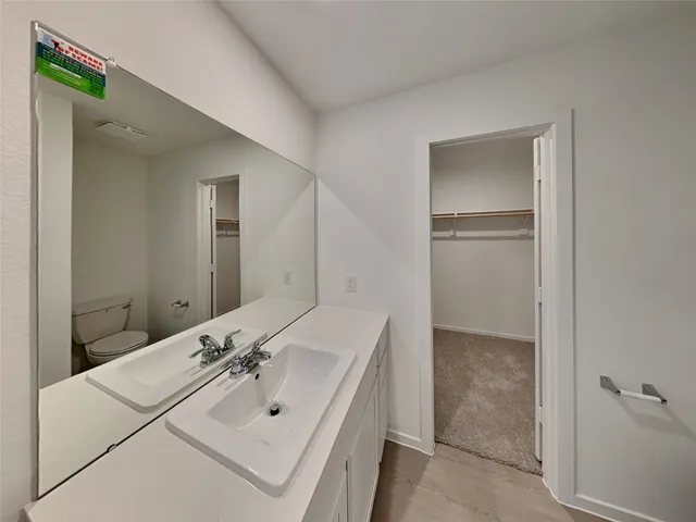 a bathroom with a sink a mirror and shower