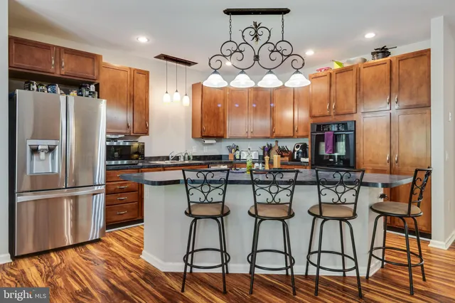 a living room with furniture and kitchen view