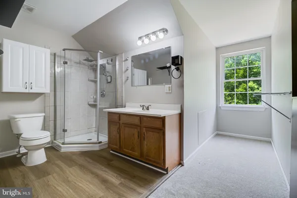 an aerial view of a house with a yard and lake view