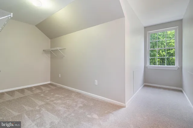 an aerial view of a house with a yard and lake view