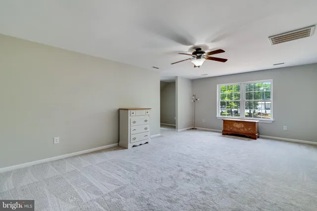 an aerial view of a house with a yard and lake view