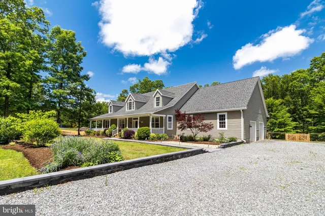 a view of a balcony with chairs and wooden floor