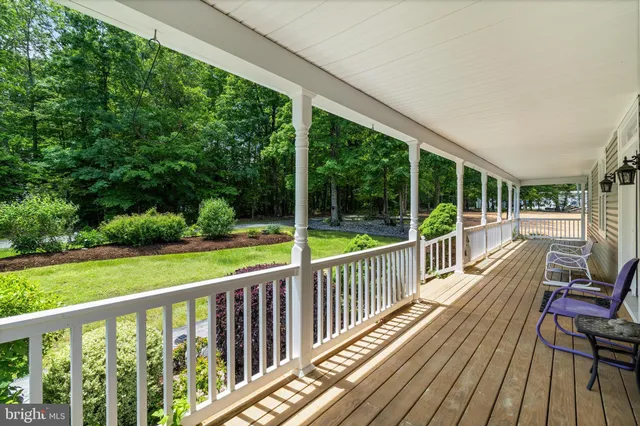 a kitchen with stainless steel appliances a table chairs refrigerator and microwave