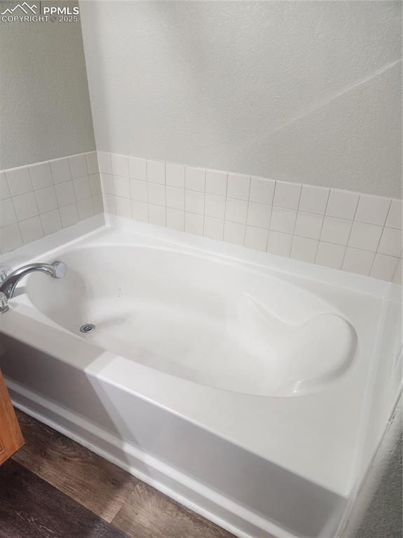 4806 Rusty Nail Point, Unit 202 Colorado Springs, CO 80916 - Photo 18 of 24 master bath with garden tub, and dark wood-style flooring
