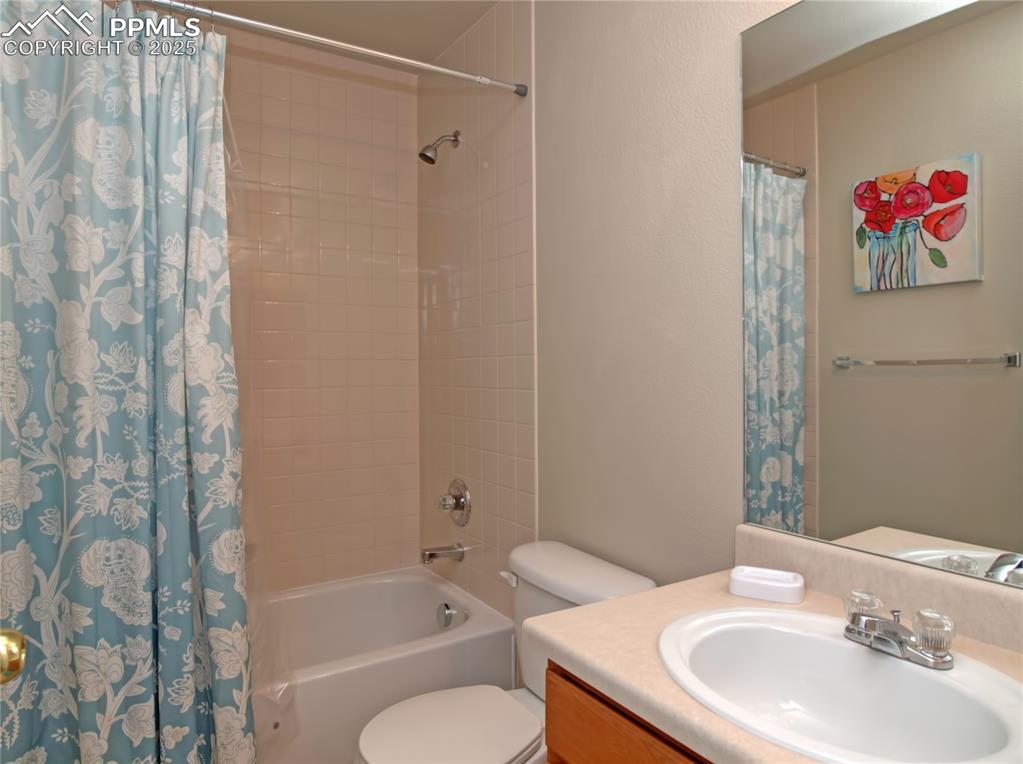 4806 Rusty Nail Point, Unit 202 Colorado Springs, CO 80916 - Photo 23 of 24 Full bathroom with shower / bath combo, vanity, and a textured wall