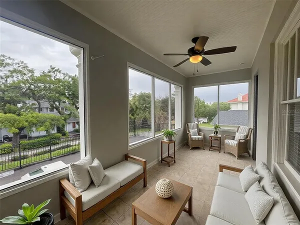 a living room with furniture and a floor to ceiling window