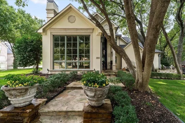 a front view of a house with a garden