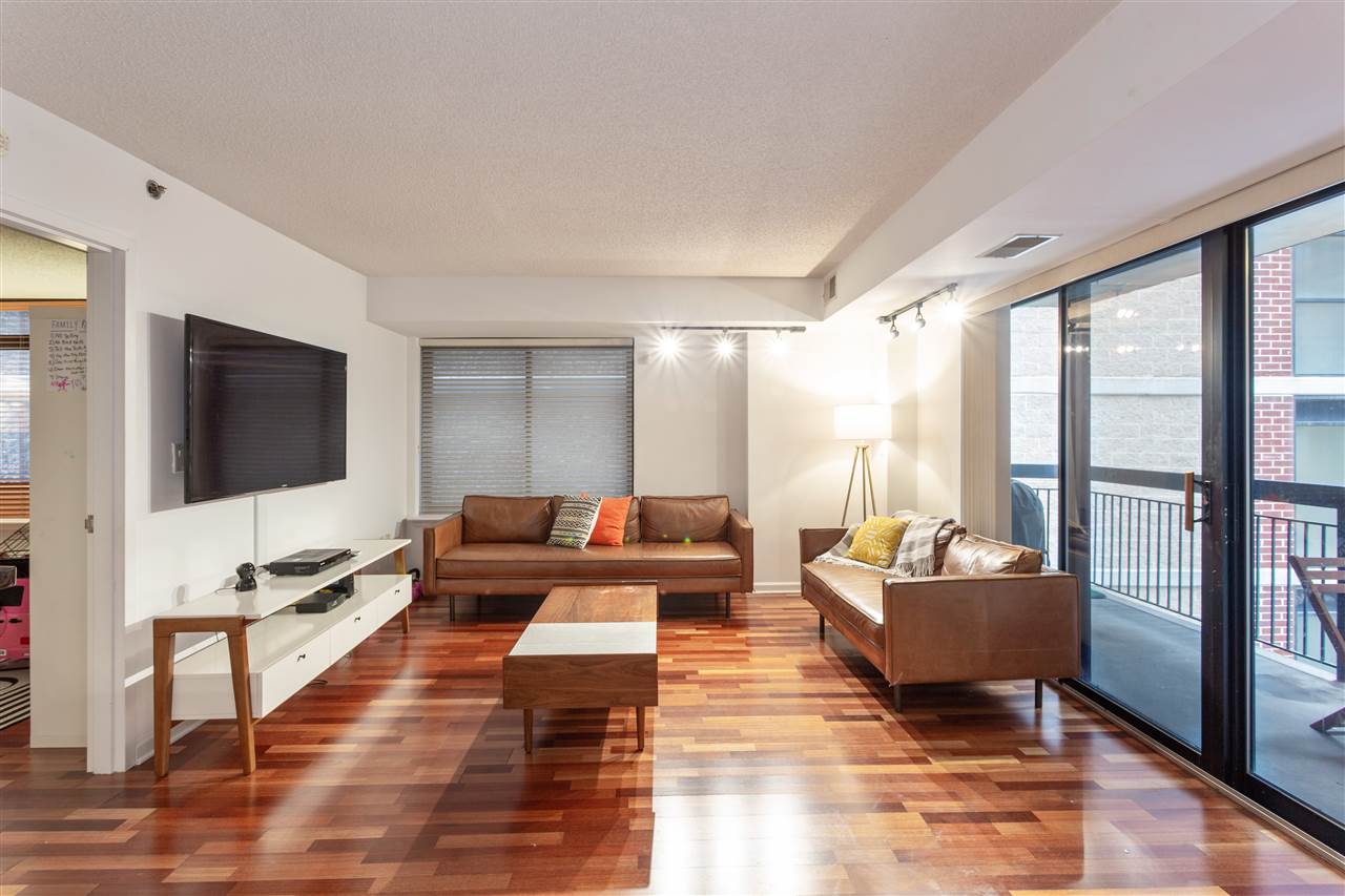 700 1st Street, Unit 3P Hoboken, NJ 07030 - Photo 1 of 1 a living room with fireplace furniture and a flat screen tv