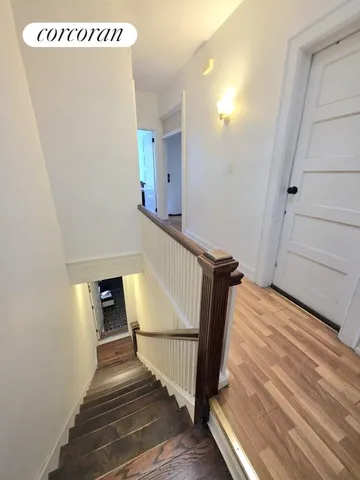 a view of entryway and hall with wooden floor