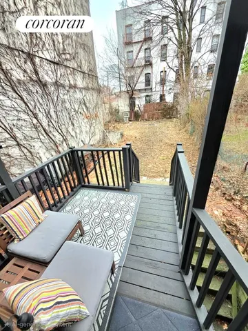 a view of balcony with wooden floor