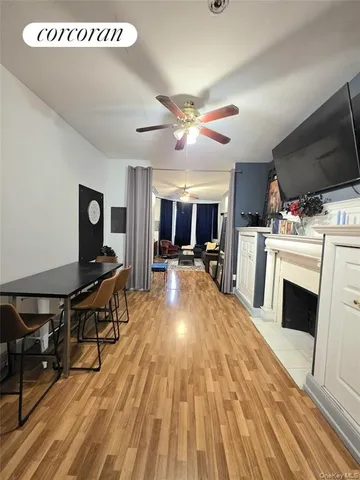 a view of a kitchen with furniture a fireplace and wooden floor