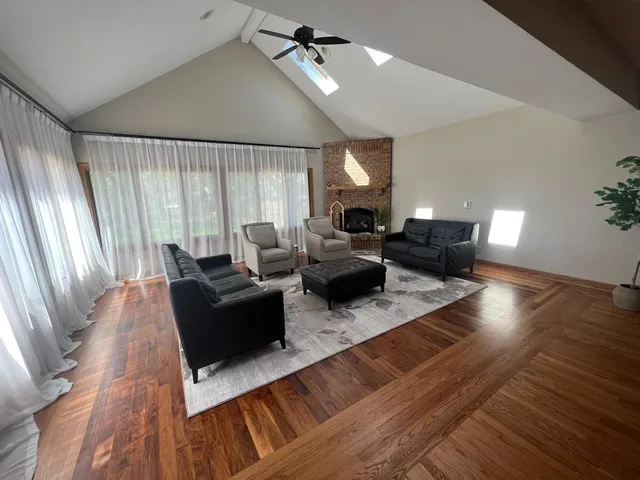 a living room with furniture windows and wooden floor