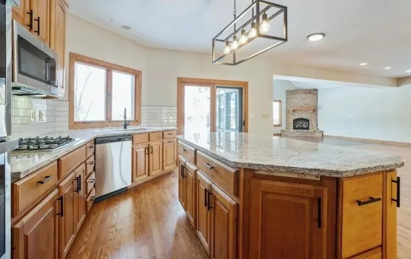 a kitchen with stainless steel appliances granite countertop a sink and stove