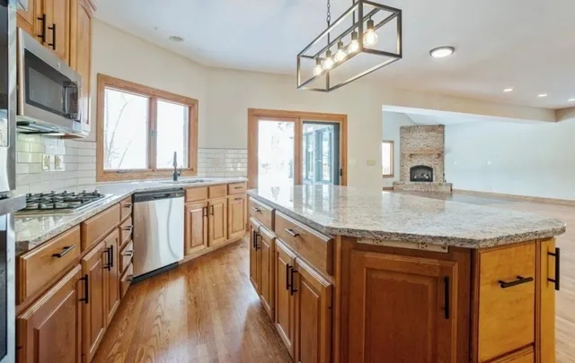 a kitchen with stainless steel appliances granite countertop a sink and stove