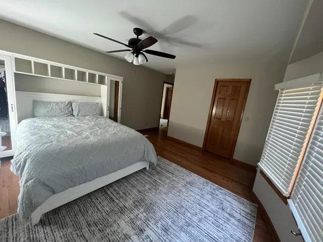 a bedroom with a large bed and a chandelier