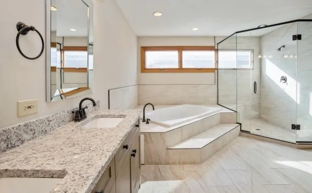 a bathroom with a granite countertop sink a toilet and bathtub