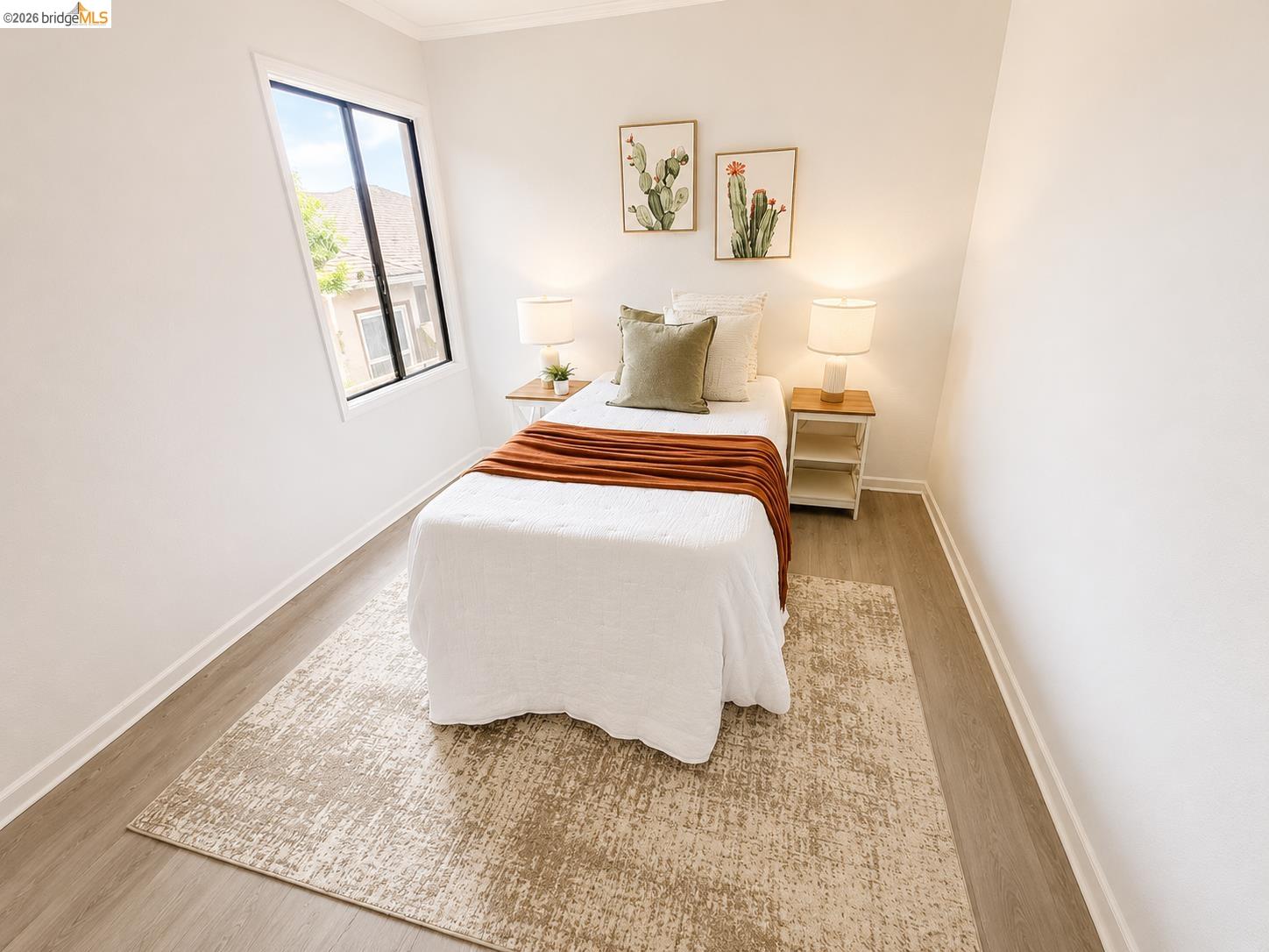 810 Pierce Street Albany, CA 94706 - Photo 10 of 25 Bright room featuring neutral wall tones, wood-finish flooring, white baseboards, and a modern window frame with dark sashes