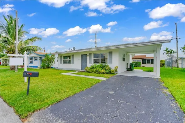 a front view of a house with a yard and porch