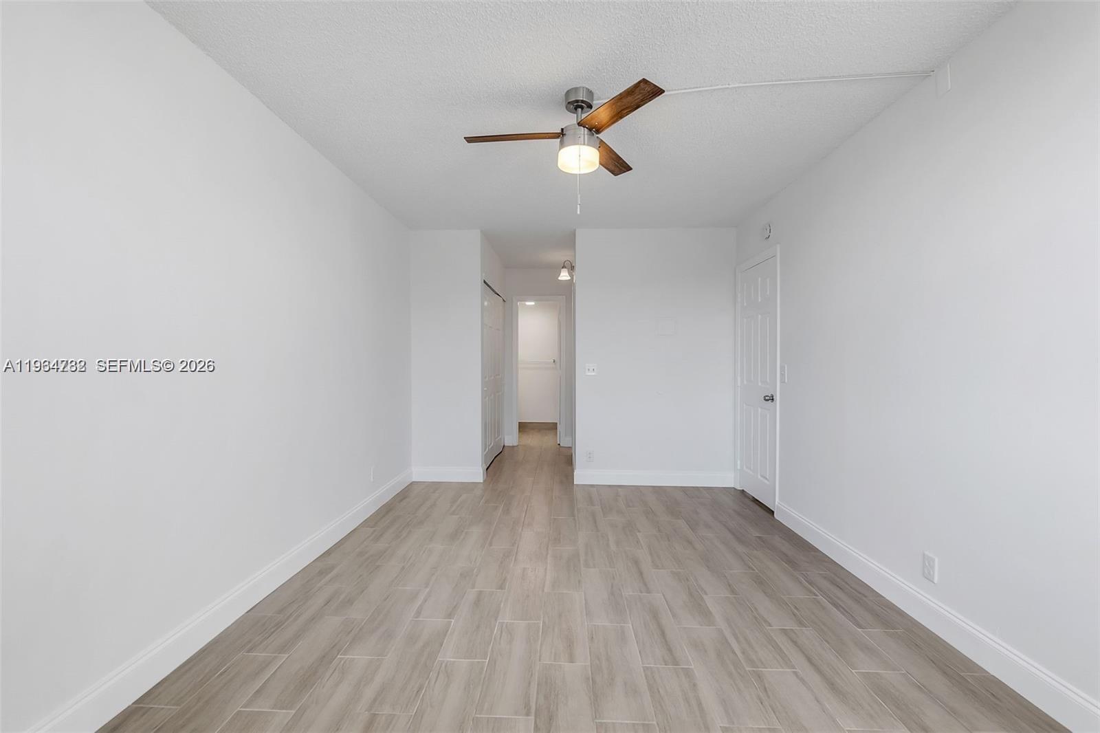 2501 Riverside Drive, Unit 307A Coral Springs, FL 33065 - Photo 13 of 29 a view of a room with wooden floor and ceiling fan