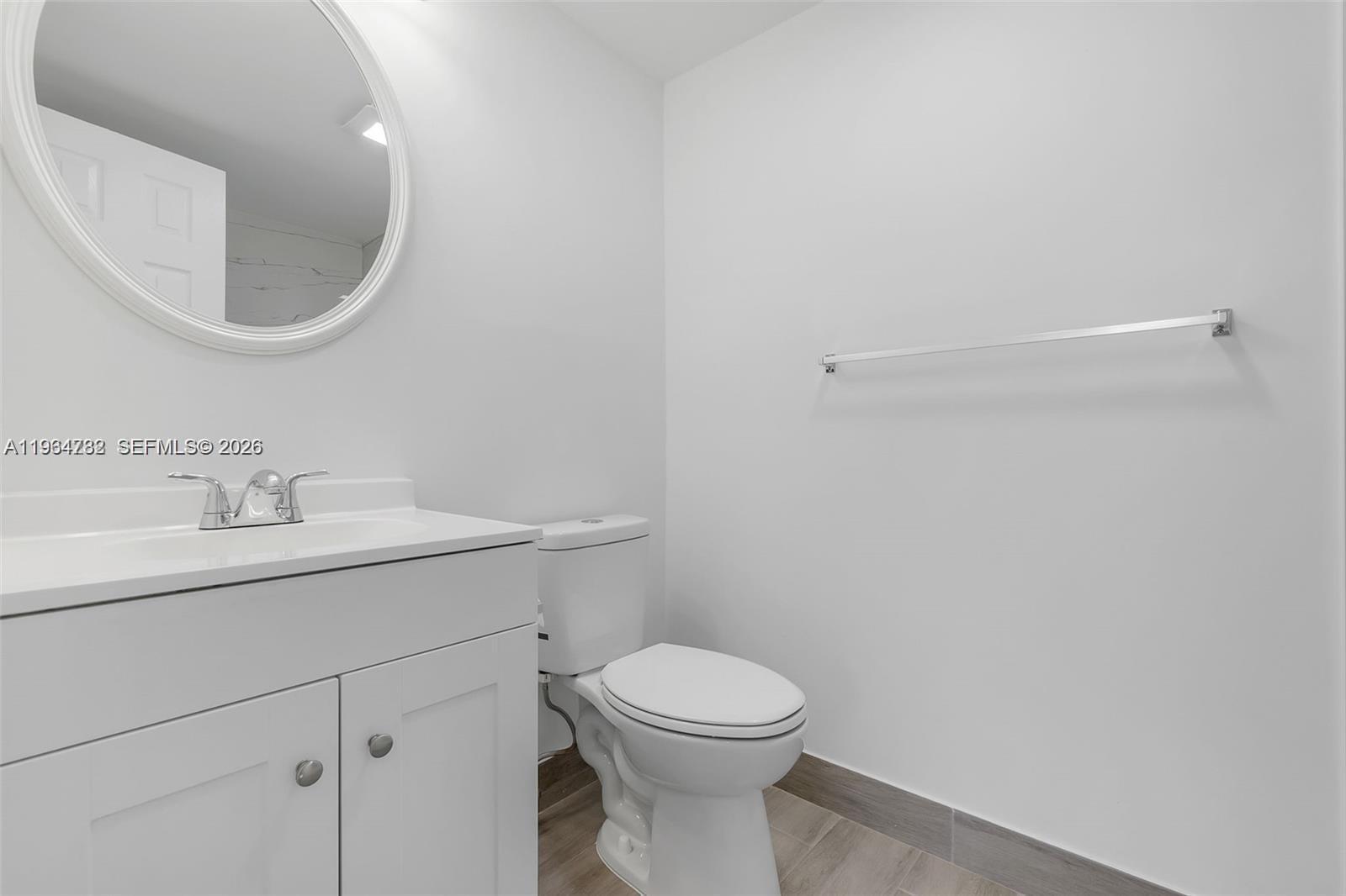 2501 Riverside Drive, Unit 307A Coral Springs, FL 33065 - Photo 17 of 29 a bathroom with a toilet a sink and mirror
