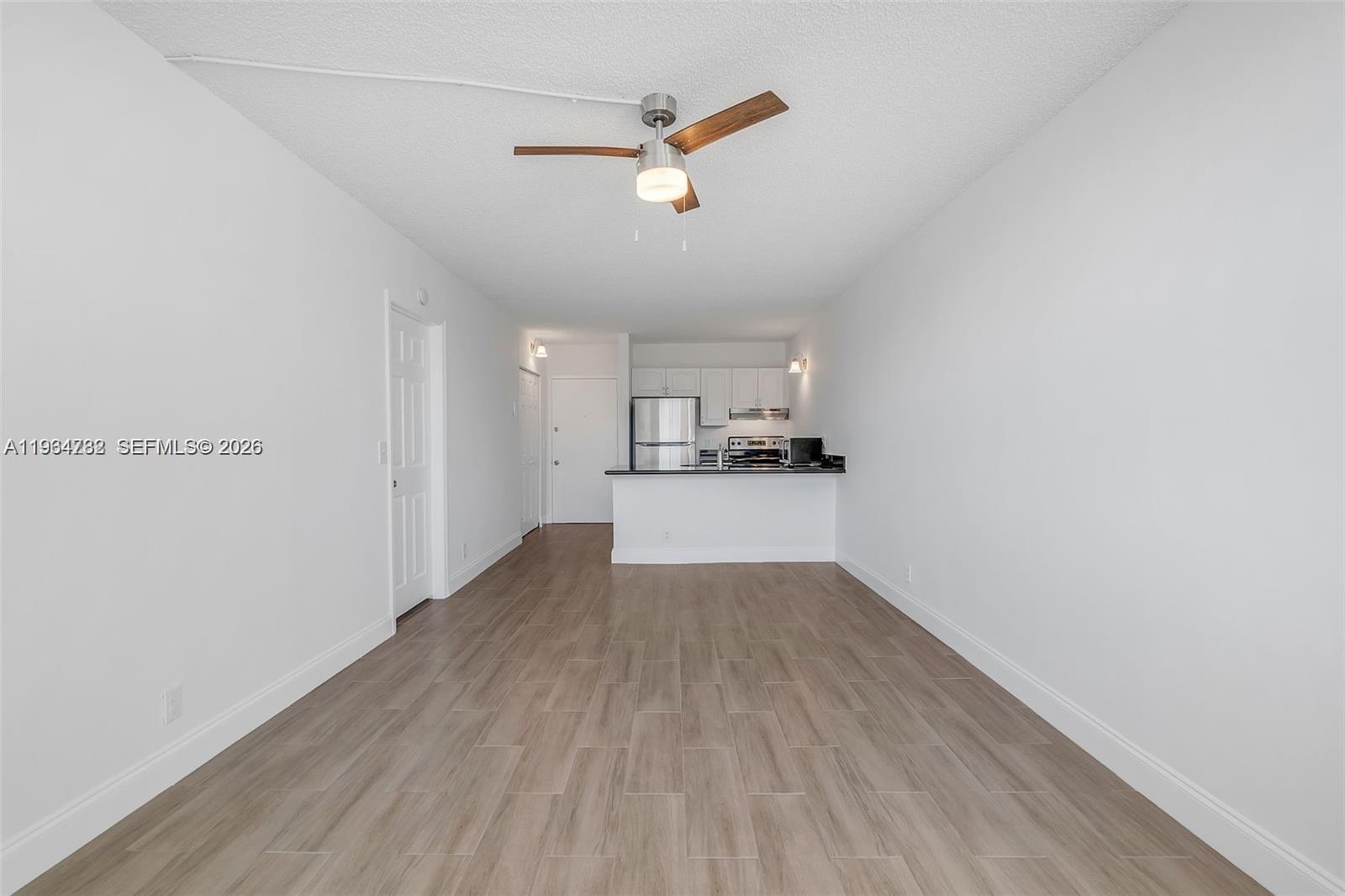 2501 Riverside Drive, Unit 307A Coral Springs, FL 33065 - Photo 3 of 29 a view of a kitchen with a sink and wooden floor