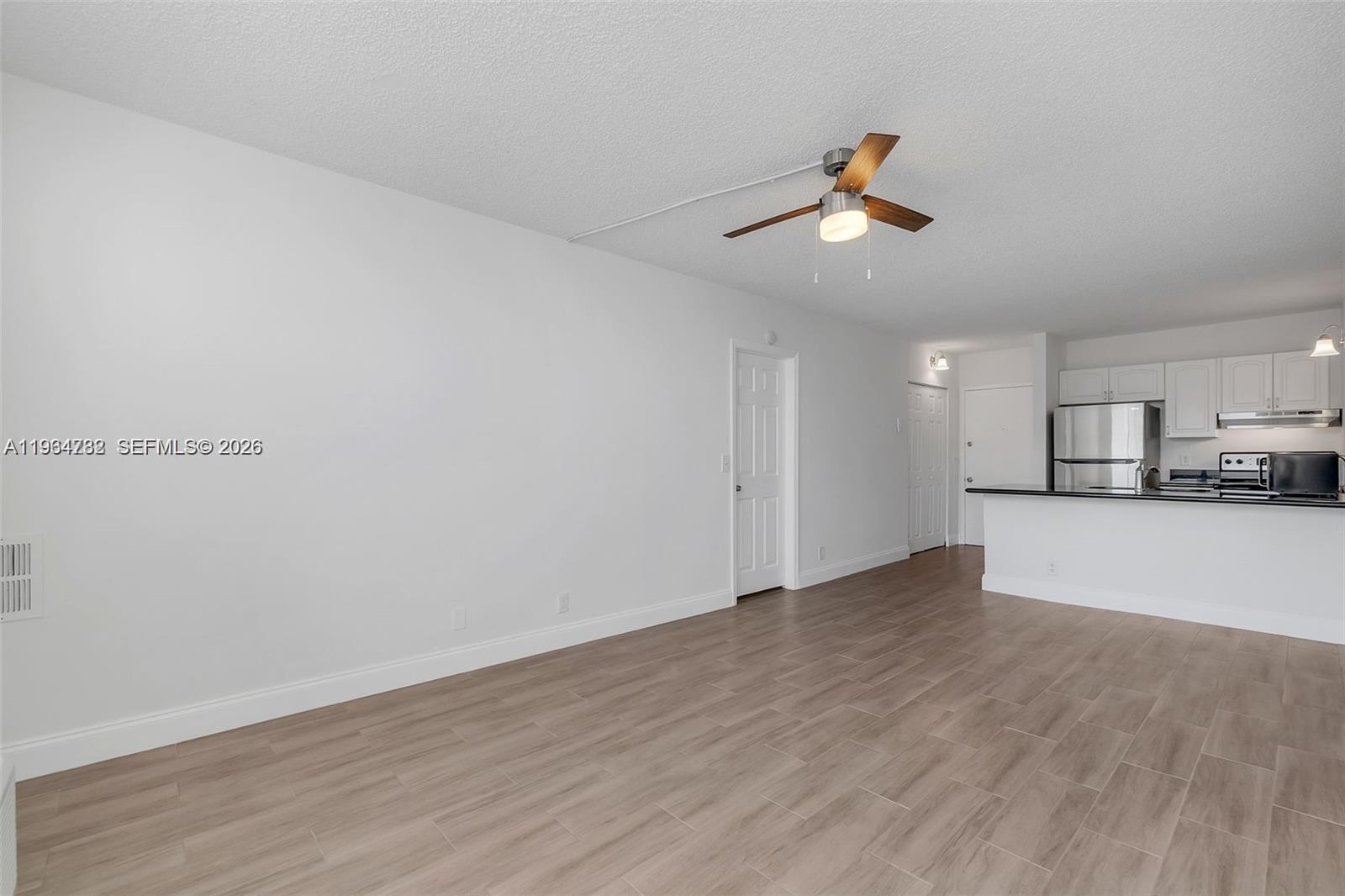 2501 Riverside Drive, Unit 307A Coral Springs, FL 33065 - Photo 4 of 29 a view of empty room with wooden floor