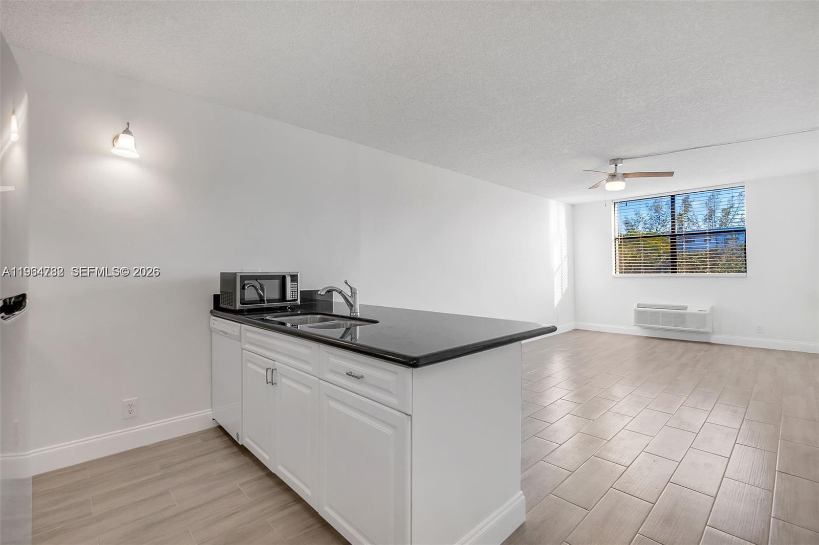 2501 Riverside Drive, Unit 307A Coral Springs, FL 33065 - Photo 10 of 29 a kitchen with stainless steel appliances granite countertop a sink and a stove