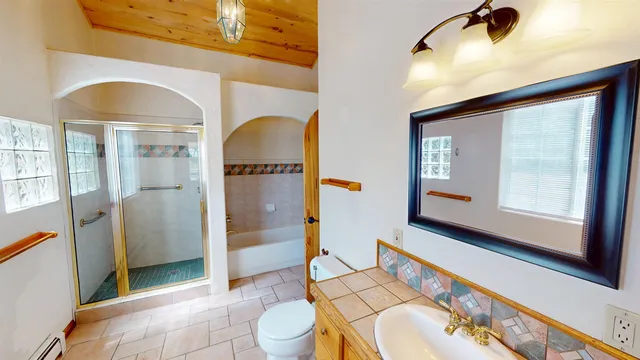 a spacious bathroom with a sink a toilet and shower