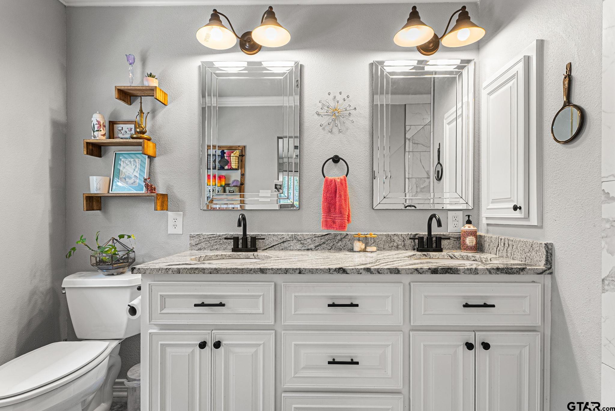 3200 Charron Avenue Longview, TX 75601 - Photo 16 of 34 a bathroom with a granite countertop sink vanity mirror and toilet