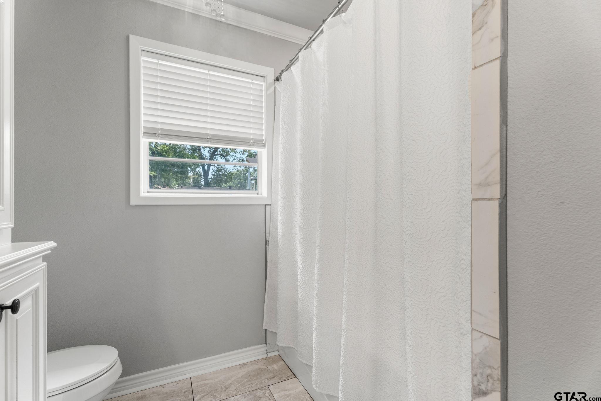 3200 Charron Avenue Longview, TX 75601 - Photo 22 of 34 a bathroom with a toilet and a shower