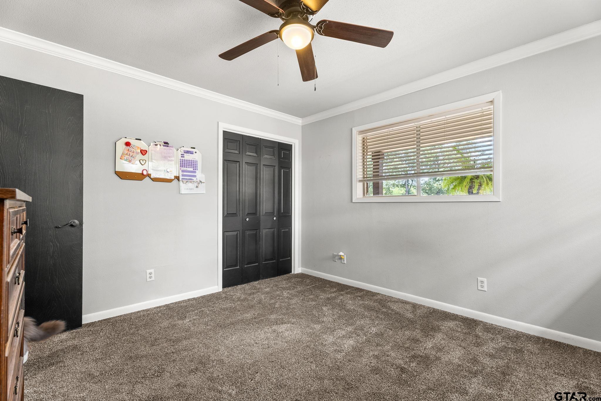 3200 Charron Avenue Longview, TX 75601 - Photo 23 of 34 a view of an empty room with window and a ceiling fan