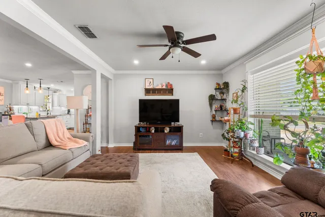 a living room with furniture and a flat screen tv