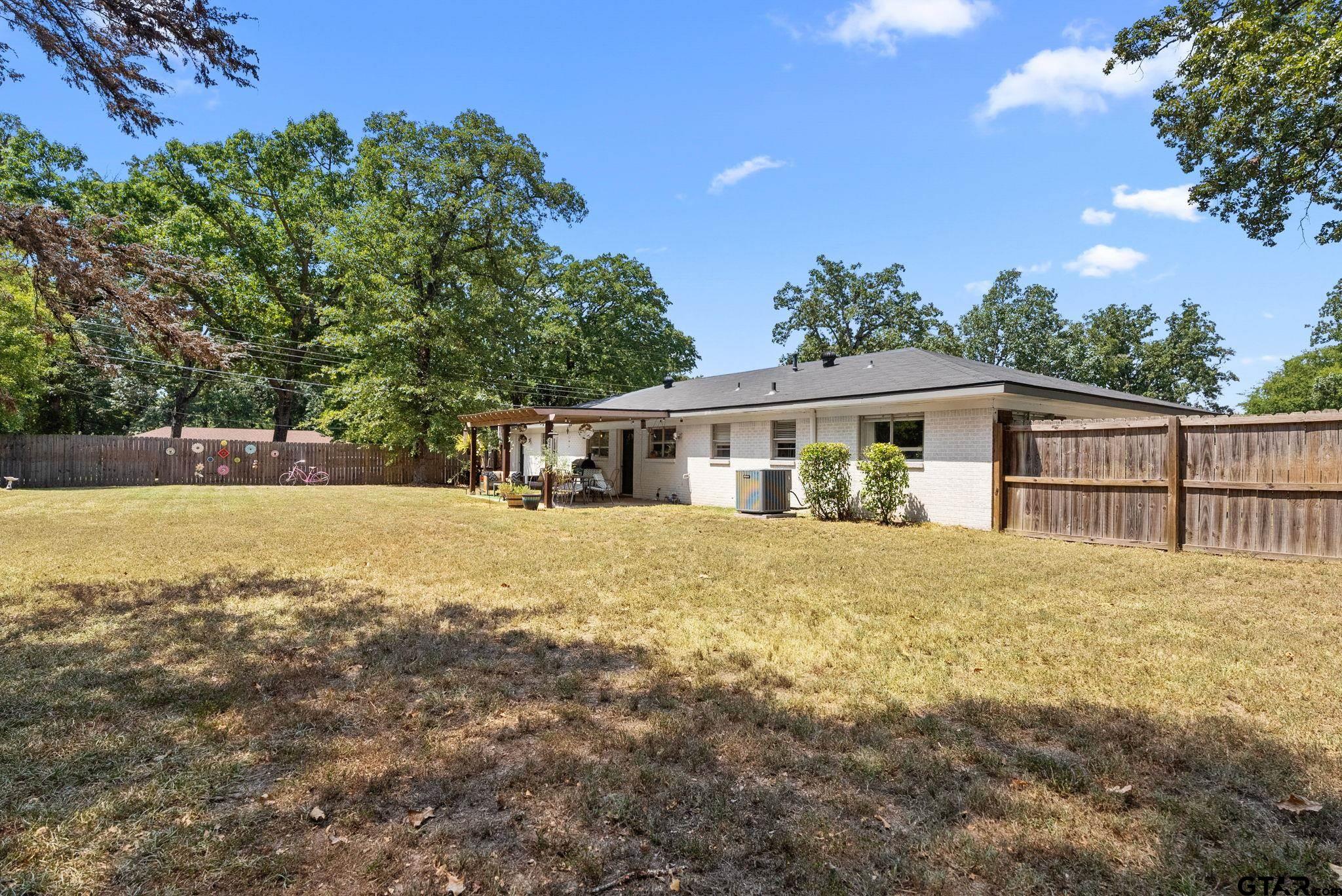 3200 Charron Avenue Longview, TX 75601 - Photo 31 of 34 a front view of house with yard and trees around